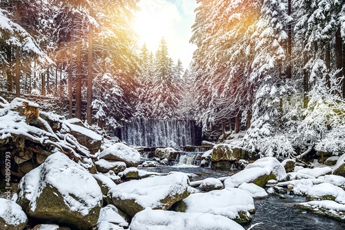 Winter waterfall , a lot of snow by the water, background of winter forest photo