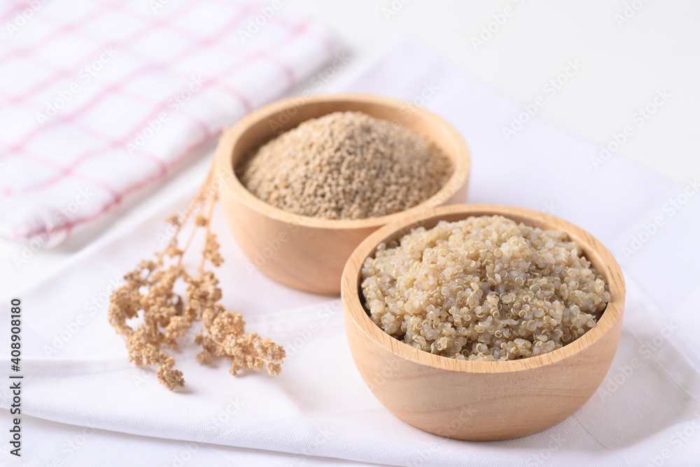 Cooked brown quinoa seeds and raw quinoa seeds in a wooden bowl, Healthy vegan food Cooked brown quinoa seeds and raw quinoa seeds in a wooden bowl, Healthy vegan food