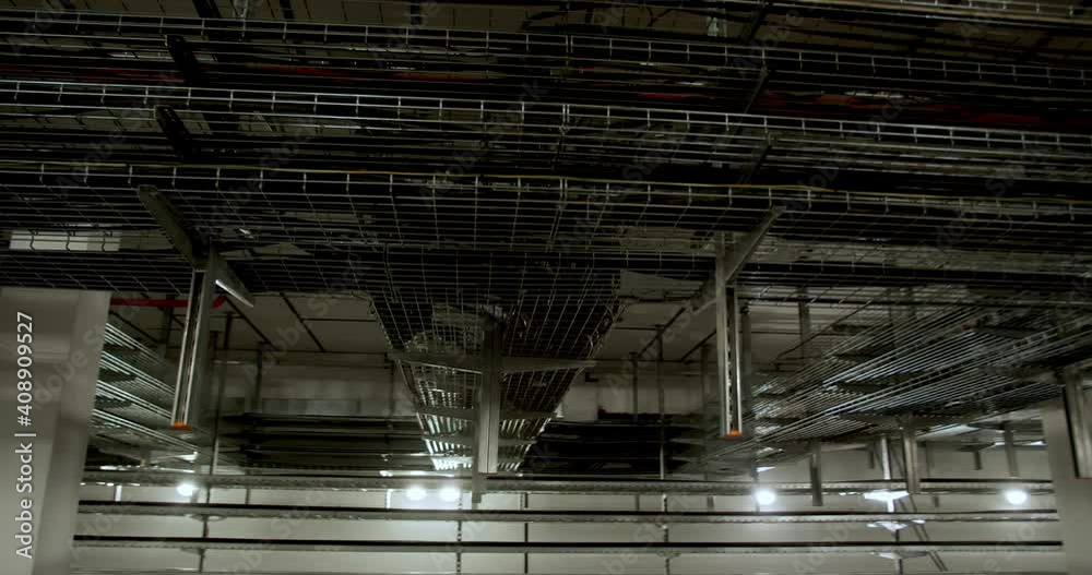 Routed cables on the ceiling in steel cages, factory facility, 4k Routed cables on the ceiling in steel cages, factory facility, 4k