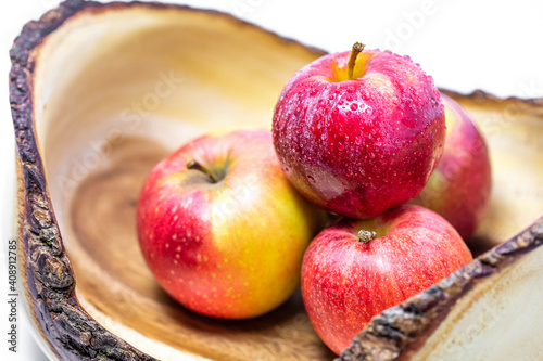 Vivid and fresh couple of red apples in wooden basket