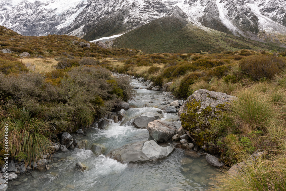 Obraz premium A small, mountain stream, on the Hooker Valley Track, Aoraki/Mount Cook National Park, Canterbury, New Zealand.