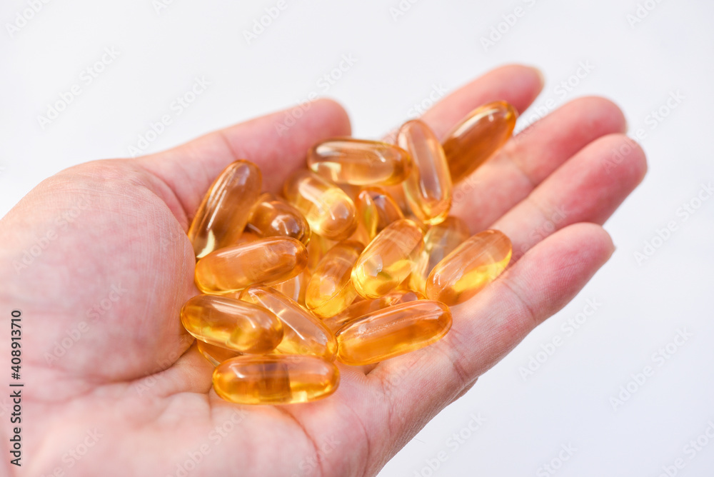 Fish oil capsules with omega 3 and vitamin D Cod liver oil omega 3 gel capsules, healthy diet concept. Fish oil capsules with omega 3 and vitamin D Cod liver oil omega 3 gel capsules, healthy diet concept.