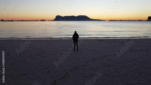 Sunset on the beach, where we can see at the bottom the city of gibraltar at the very first hour of the day, this video was taken from Algeciras bay.