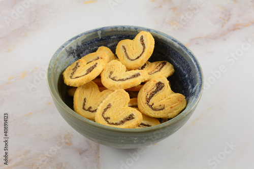 Dutch black olive cheese biscuits in ceramic snack bowl on table