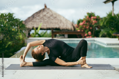 Woman yoga on the terrace. Home training. Holiday yoga