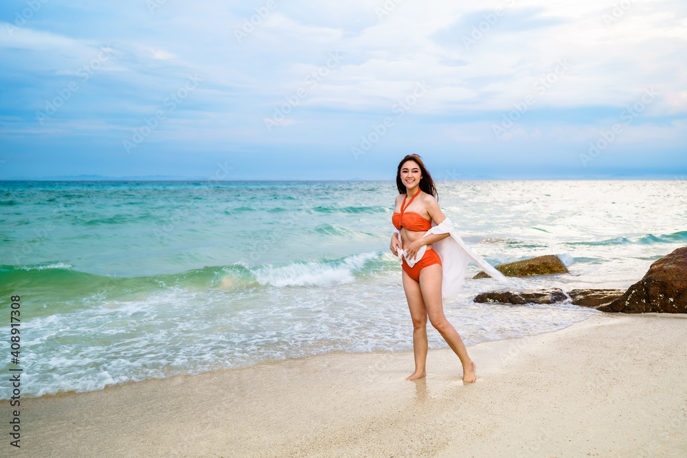 happy woman in the sea beach at Koh MunNork Island, Rayong, Thailand.