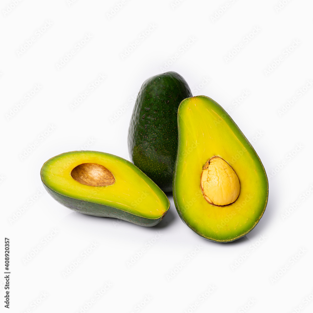 sliced avocado with a bone on a white background with reflected shadows sliced avocado with a bone on a white background with reflected shadows