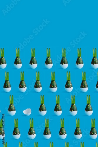 Colorful easter pattern of green avocado bunny in blue, green and white. Minimal background. Front view. Copy space