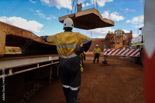 Safe workplace crane lifting safety supervisor conducting safety check on workers while crane being lift heavy load construction mine site, Perth, Australia 