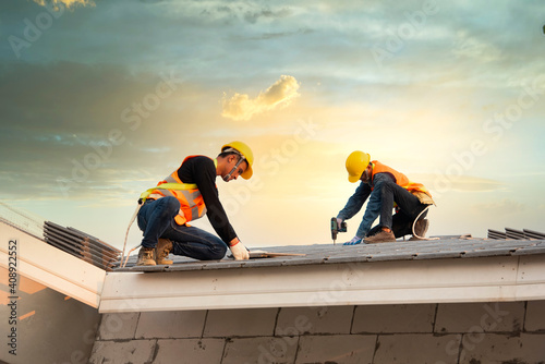 Canvas Print Asian engineer workers install new CPAC roof, roofing tools, electric drill, use on new roof with CPAC roof house construction idea
