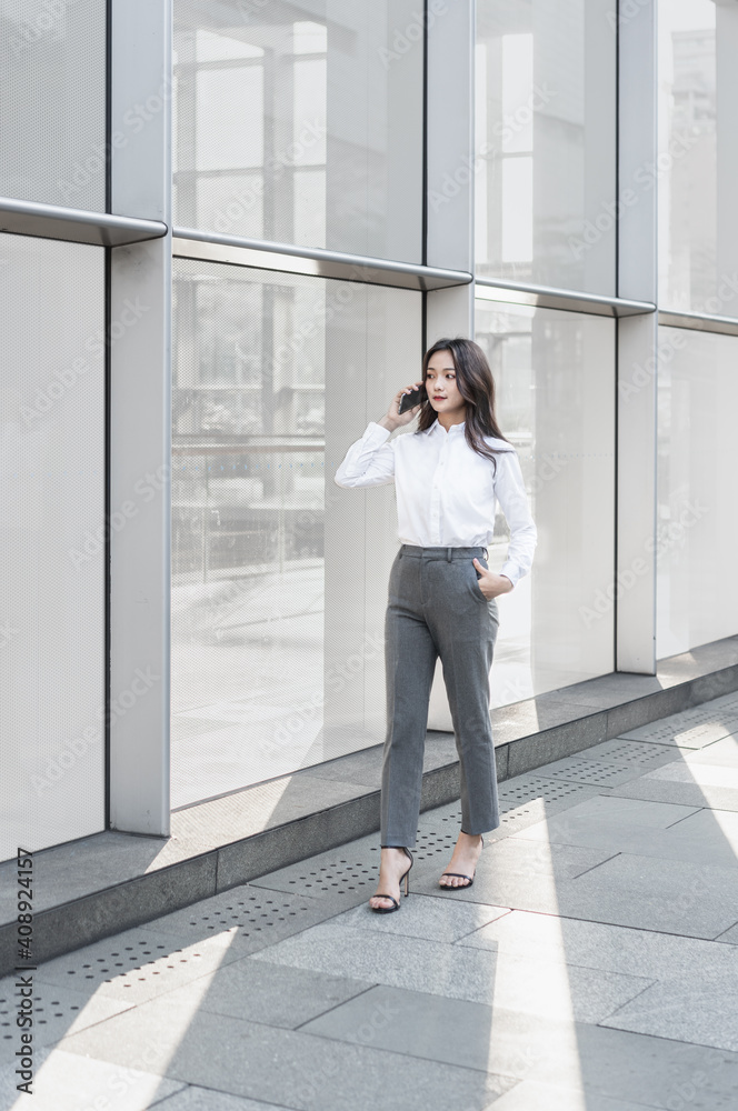 businesswoman talking on cell phone while walking businesswoman talking on cell phone while walking