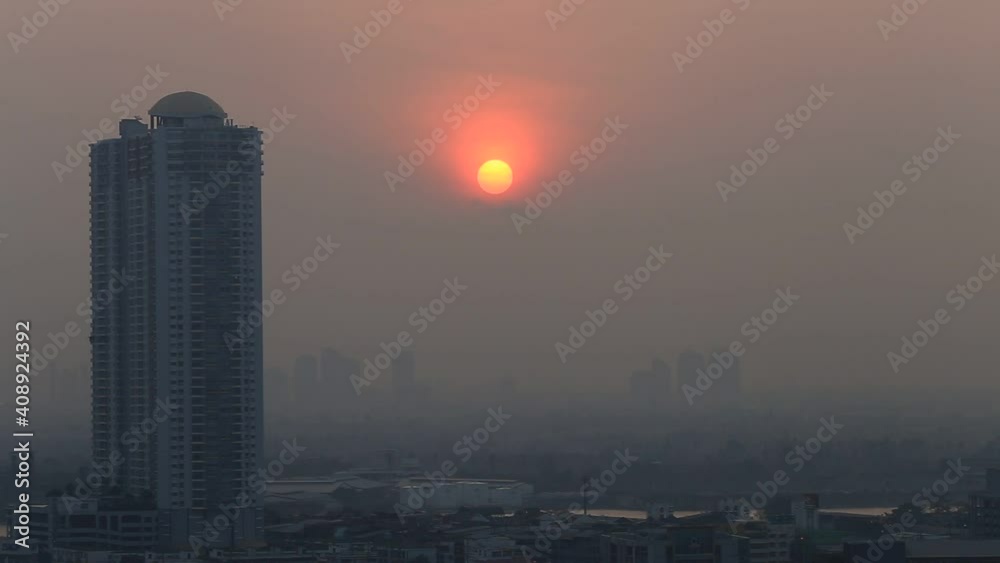 The video background of the morning light in the midst of tall buildings and the blurred breeze or the small dust emitted by the air, the sun can be seen round above the sky. The video background of the morning light in the midst of tall buildings and the blurred breeze or the small dust emitted by the air, the sun can be seen round above the sky.