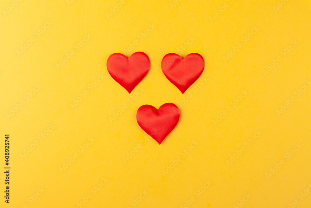 Red hearts on colored yellow background, valentine's day greeting card