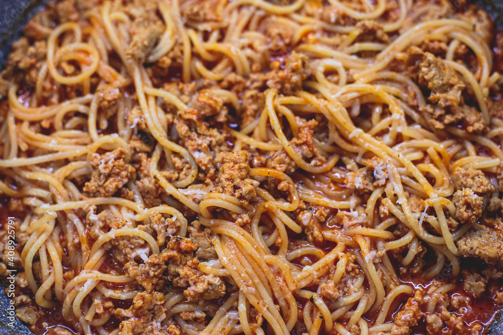Pasta bolognese pan, homemade prepared close up view, classic italian spaghetti noodle with minced meat beef, tomato sauce and parmesan cheese
