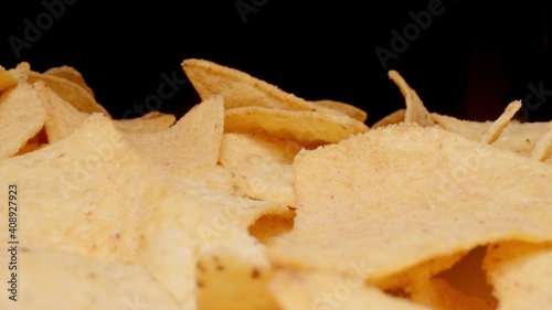 MACRO: Potato chips on a black background