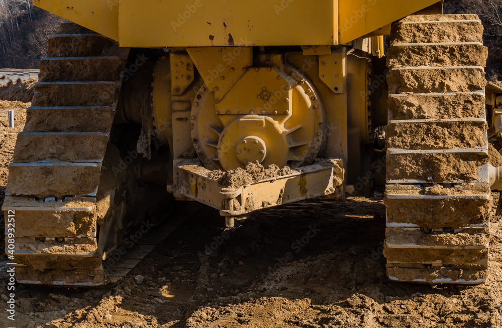 Fototapeta premium Rear of bulldozer tracks sitting at new construction site.