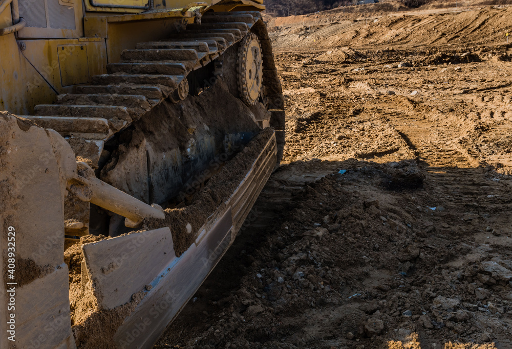 Bulldozer tracks sitting at new construction site.