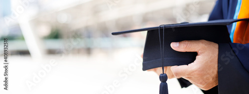 graduates ,close up student holding hats and tassel black in hand during commencement success of the university, Concept education congratulation. Graduation Ceremony.