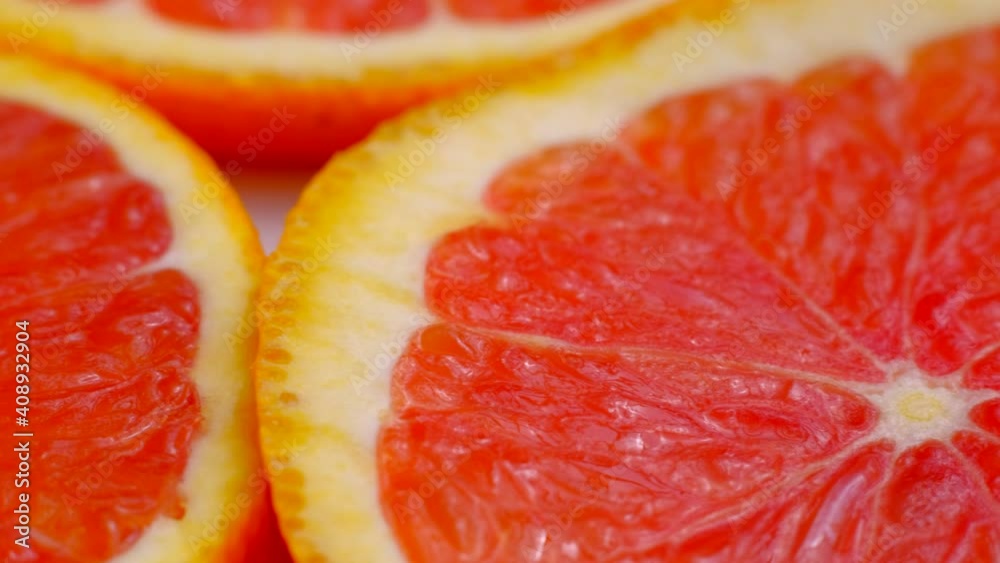 Macro Round Fresh Juicy Sliced Slices Of Red Citrus Orange. Dolly or slider shot. Pieces of Grapefruit Fruit Isolated, Close-up. The Concept Of Healthy Eating. Macro Round Fresh Juicy Sliced Slices Of Red Citrus Orange. Dolly or slider shot. Pieces of Grapefruit Fruit Isolated, Close-up. The Concept Of Healthy Eating.