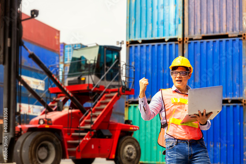 Foreman is giving a signal to work in the harbor. To move the cargo container onto the ship. Foreman looking forward on Forklifts in the Industrial Container Cargo freight ship.