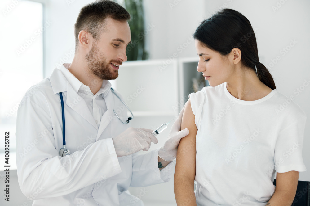 doctor in hospital giving injection to female patient vaccine protective gloves doctor in hospital giving injection to female patient vaccine protective gloves