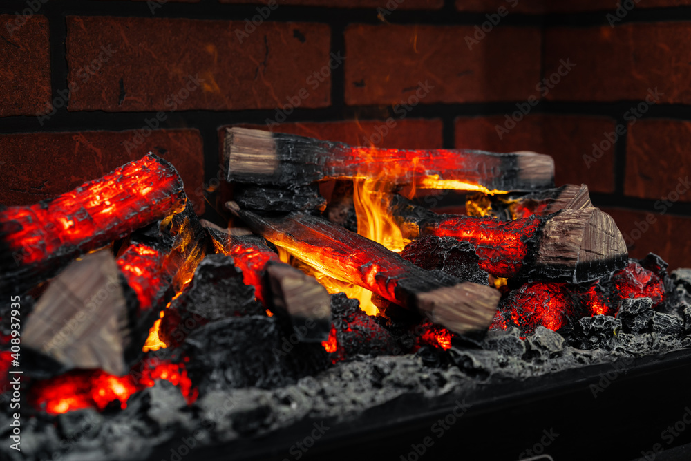 Close up of a fireplace with burning wood logs inside