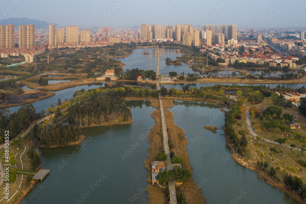 Aerial view of Anping Bridge, an ancient Song dynasty stone beam bridge in Fujian province with city skyline at dusk