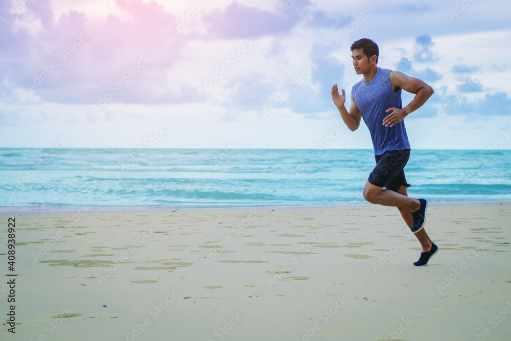 Man running athletes at the beach with cloudy sky.	