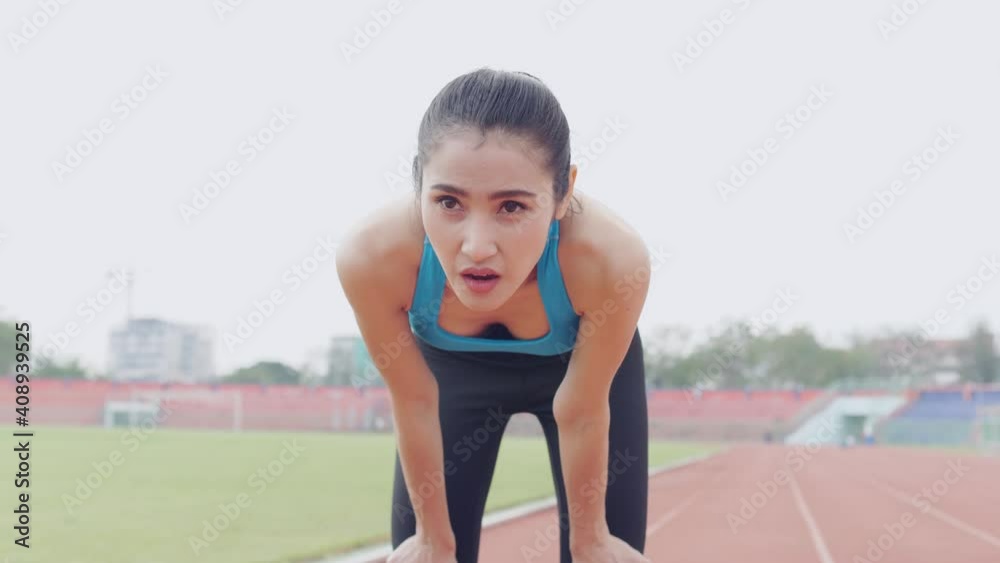 Tired asian woman runner taking a rest after running hard . Tired asian woman runner taking a rest after running hard .