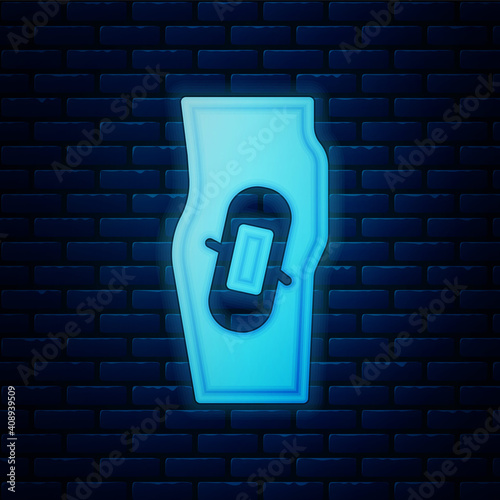Glowing neon Plaster on leg icon isolated on brick wall background. Vector.