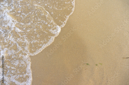 Sea surf, waves rolls on a sandy beach