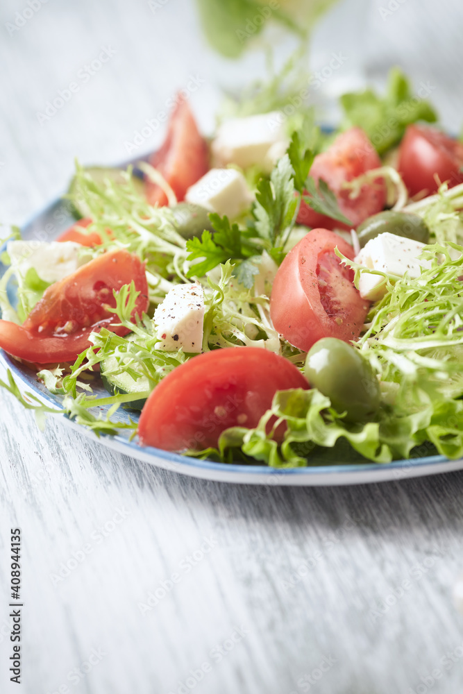 Salad with Green Olives, Tomatoes and Feta Cheese. Bright wooden background. Copy space. Salad with Green Olives, Tomatoes and Feta Cheese. Bright wooden background. Copy space.