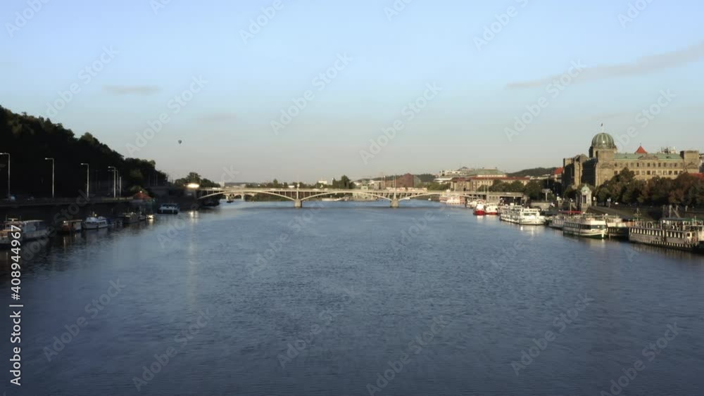 Vltava river in Prague,Czechia,with anchored boats on each side,bridge. Vltava river in Prague,Czechia,with anchored boats on each side,bridge.