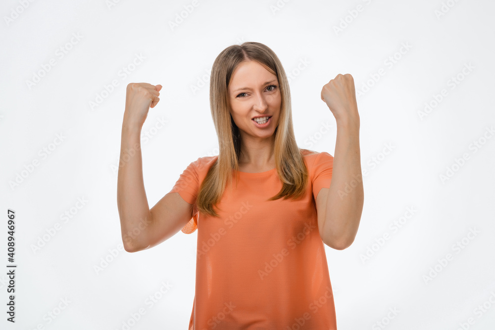 Happy blond girl clench fists and shouting yes, celebrating victory, achieve goal. Studio shot, white background Happy blond girl clench fists and shouting yes, celebrating victory, achieve goal. Studio shot, white background