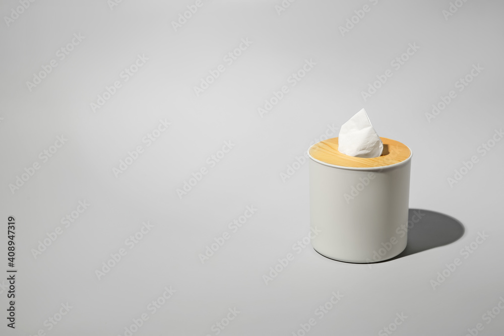 Holder with paper tissues on light grey background. Space for text Holder with paper tissues on light grey background. Space for text