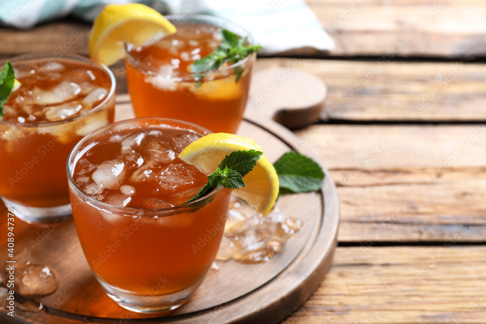 Delicious iced tea on wooden table. Space for text Delicious iced tea on wooden table. Space for text