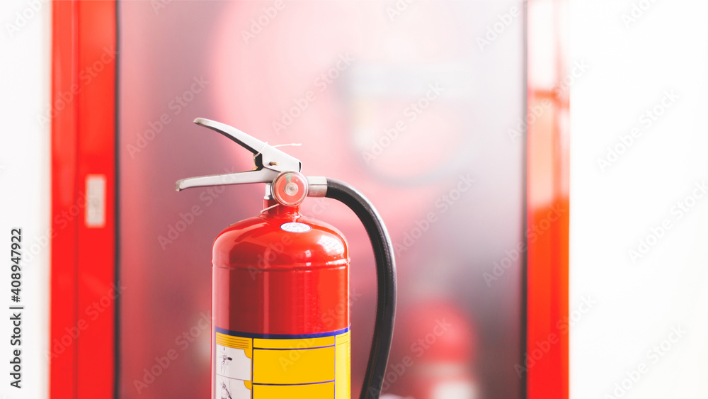 Obraz premium The red fire extinguisher is ready for use in case of an indoor fire emergency.