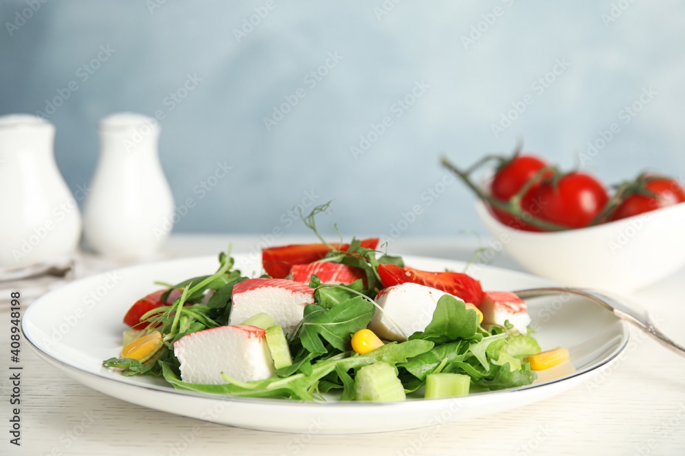 Tasty crab stick salad served on white table, closeup. Space for text Tasty crab stick salad served on white table, closeup. Space for text