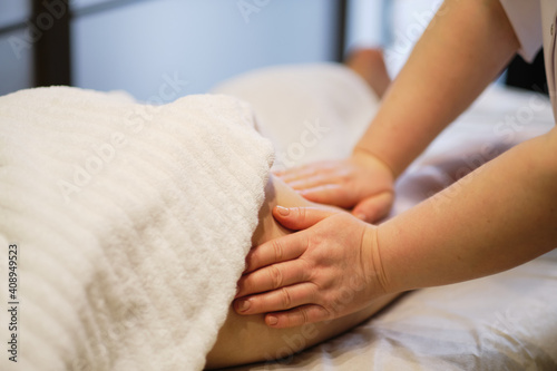 Body care concept. Special anticellulite treatment. Masseur makes anticellulite massage young woman in spa salon. Close up view