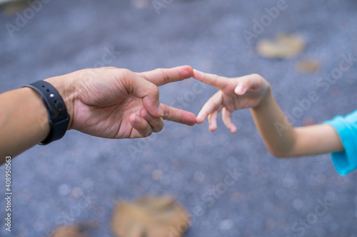 Little child and father bumping fists, man and child giving knuckle bump. © Nutt