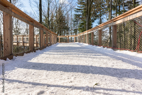Fototapeta Naklejka Na Ścianę i Meble -  Wooden path of observation tower amogns the trees