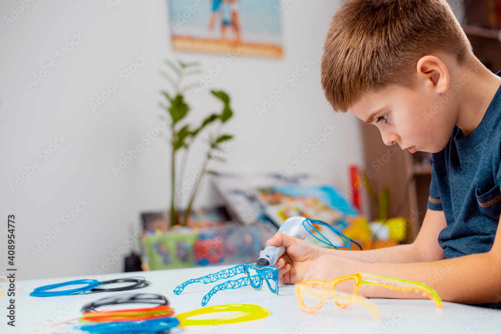 Focused child with 3d printing pen creating a toy Stock Photo | Adobe Stock