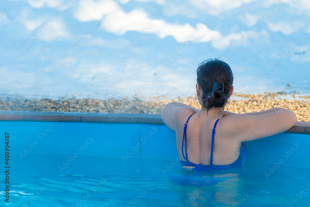 Woman enjoying the panoramic view from the pool