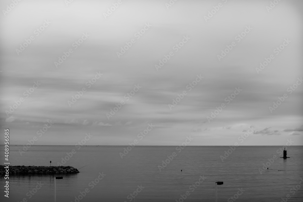 Minimalist landscape of the quiet beach of Gijón, Asturias, Spain.The photo is in black and white and aims to convey tranquility and calm. Minimalist landscape of the quiet beach of Gijón, Asturias, Spain.The photo is in black and white and aims to convey tranquility and calm.