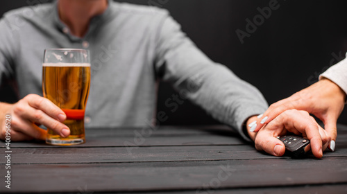 Drunk man with car key and alcoholic beverage in bar, closeup. Don't drink and drive concept