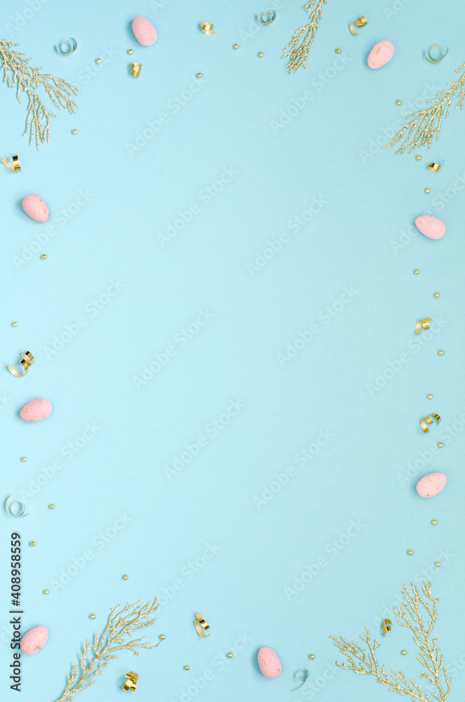 Easter holiday background with pink easter eggs, golden twigs and decor on a blue background