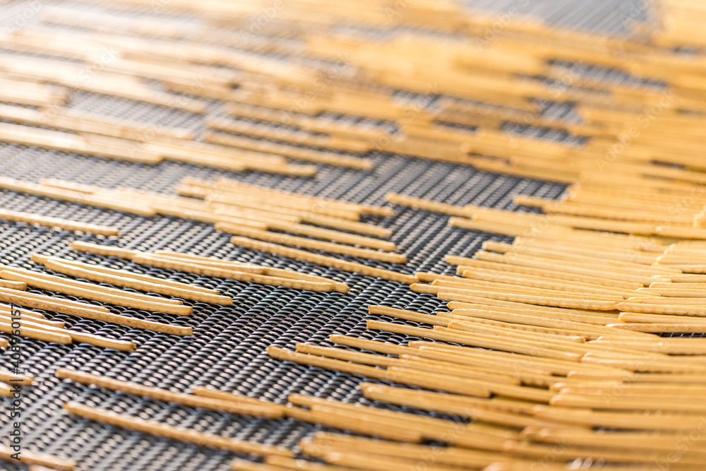 Crunchy bread sticks on conveyor belt at manufacture Crunchy bread sticks on conveyor belt at manufacture