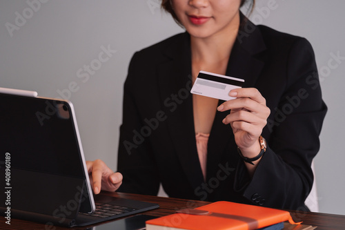 Busiesswoman holding creditcard and using laptop computer for online shopping, Online Payment, e-commerce, internet banking. photo