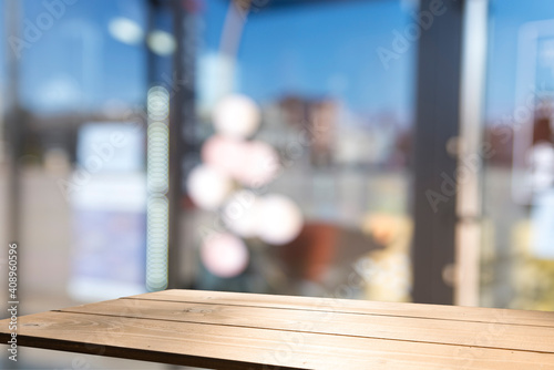Empty dark wooden table in front of abstract blurred background of coffee shop . can be used for display or montage your products.Mock up for display of product.