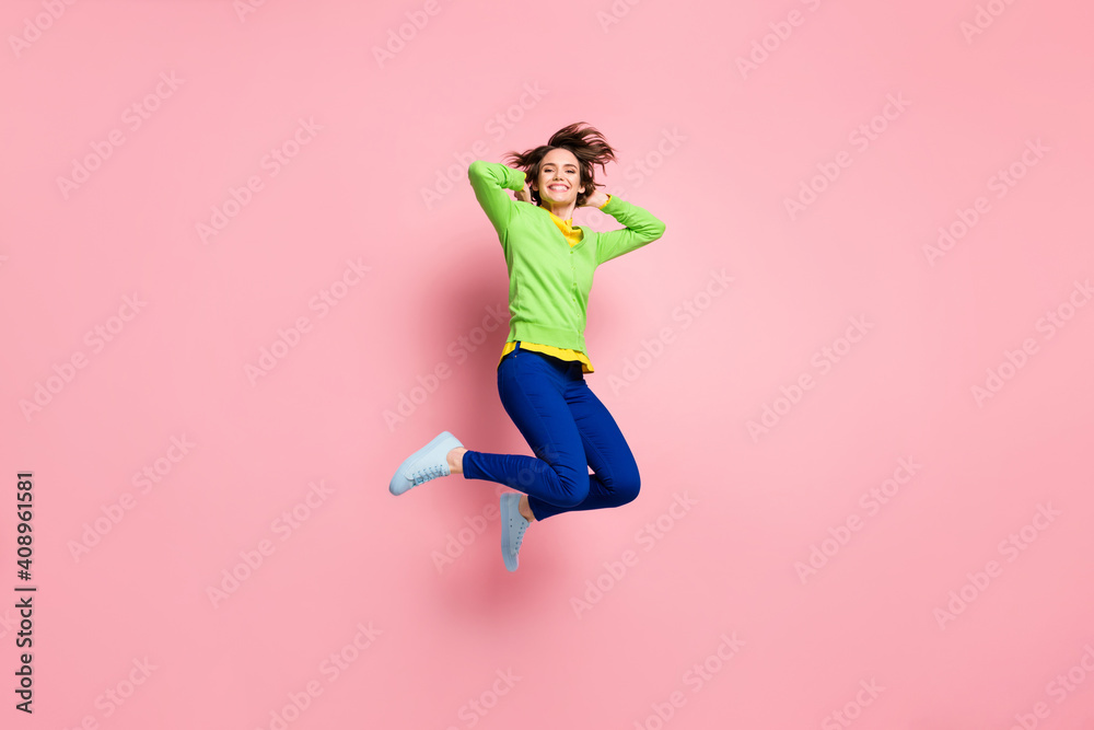 Full size photo of young excited girl happy smile have fun enjoy carefree jump up isolated over pink color background